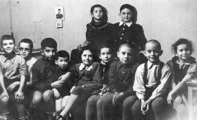 1952 - A birthday (8/10/1952), Tallinn
Left to right.
Sitting: Leonid Schats, Mark Rybak, Boris Besprosvanie, Ruben Murschak, Ilona Wolfson (Trapido), Olga Glubokovski (Amitan), Grigori (Gera) Trapido,  Marek Pakkin, Irina Amitan
Standing: Bella Popov (Murschak), Evgeni Berezovski 
... and with J. W. Stalin on the wall calendar
Keywords: [T] [M]