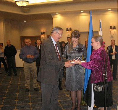 2 Mark Rybak receiving the White Star order from Mrs Ambassador
in the middle Estonian Chargé d'affaires in Israel Miss Marin Mõttus
