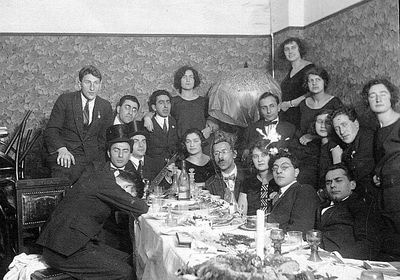 company - the same company again
Left to right.
Around the table: Leo Markovitsch, Anna Levin (Rogovski), Nosson Gens, Raja Drabkin (Feinstein), ?, Mischa Bakscht
Standing: ?, ?, Dobruschkes?, ?, ?, Samuil Levin, Anna Feinstein, ?, ?, Margarete Elian, ?
