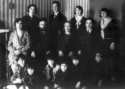 Gurevitsch family - Valga
Left to right
Top row: Rosa Gurevitsch - killed by nazis in Riga, Jakov Gurevitsch - after WWII died in Israel, Sara Gurevitsch - killed by nazis in Estonia, Selma Gurevitsch - left to Africa before the WWII (order not known - Selma, Sara), 
Middle row: Hanne (Anna) Gurevitsch died in Cheboksari during the WWII from hunger, Leib Gurevitsch (The rabbi of Valga, b. 1872, died in Valga before the WWII), Slate Gurevitsch (Judeikin) - b. 1882, died in Viljandi in 1952, Abram Gurevitsch (b. 1906, rabbi in Viljandi and Tallinn, died in Tallinn in 1983)
Bottom row: Lida Sulkin (daughter of Hanne) - in Canada, Bubi (son of Hanne) - died, Ida Grabe (Gurevitsch) - b. 1923, died in USA, Miriam Lazikin (Gurevitsch) - b. 1925, lives in Jerusalem, Bella (Berta) Israeli (Gurevitsch) - lives in kibuz Kfar Blum
On the wall - Keren Kayemet box
