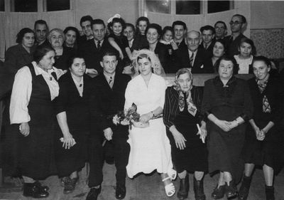 Raichmann Harry mariage in synagogue - 1955
Left to right.
First row: ?, Deborah Bam (Rybak) from Riga, Harry Raichman, Ida Raichmann (Bam), Taube Bam, Sina Sverdlov, ?
Standing: ?, ?, ?, ?, ? (all relatives from Riga), Rafael Bam, Eda Bam, Haja Judeikin (Raichmann), Rina Hecht (Bam), Raja Bam (Koslovski), Boruch Bam with Deborah Bam, Bere Raichmann, Zion Bam, Isi Raichman, Leo (Arie) Raichmann 
