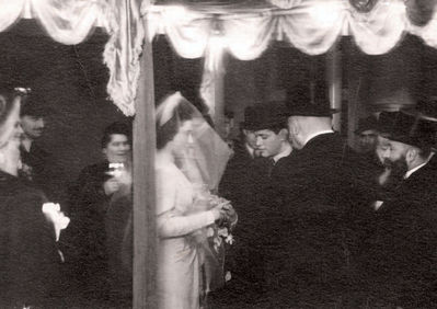 Koslovski wedding - December 1940
This is the wedding photograph of my [Rachel Randvee] sister Riva Koslovski, nee Tsivian. It was taken in Tallinn in 1940.
My sister married in December 1940. Her husband, Yakov Koslovski, also graduated from the Jewish school albeit four years earlier than Riva. Their wedding was quite modest with only close friends and relatives present. Some arrests and nationalization of property had already
taken place in Tallinn by that time so it wasn't really a very joyful time. Meishe Furmanski, Aunt Rasse's husband, died just before the wedding, the funeral was held on the wedding day, and many of the relatives were attending that event. The wedding ceremony took place in the synagogue's registry office and was conducted by Aba Gomer, the chief rabbi of Estonia.
Keywords: [Religion]