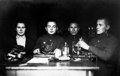 Schloma Spungin (second from left) in Kuperjanov battalion (1931/2) - cleaning gas masks.
